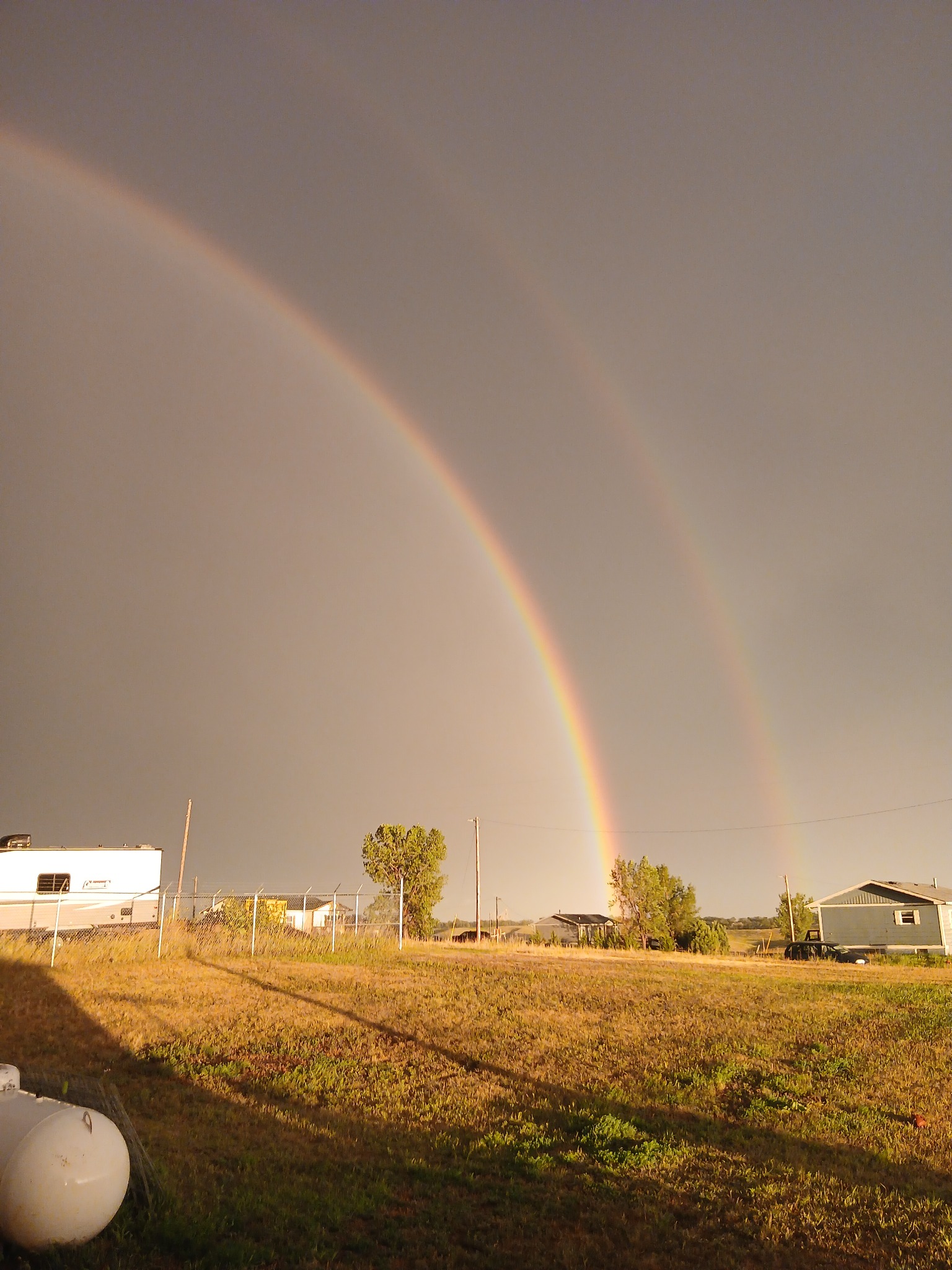 Double rainbow over a rural community